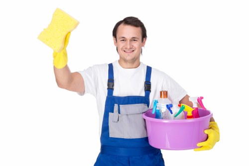 Cleaners Brixton team member using safe cleaning practices with protective equipment